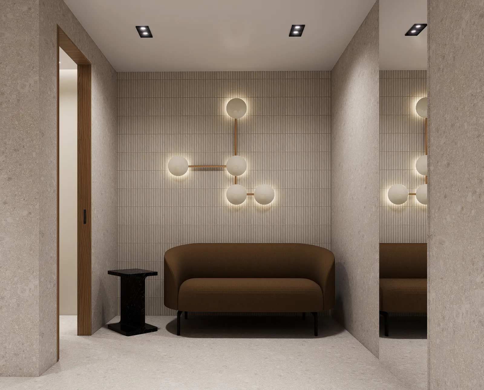 Lounge alcove with a curved sofa and a brass sculptural wall light