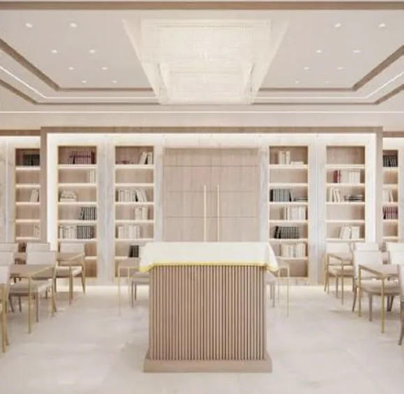 Bright shul with oak lectern, bookshelves and a crystal ceiling fixture